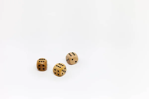 three wooden game dice on white background