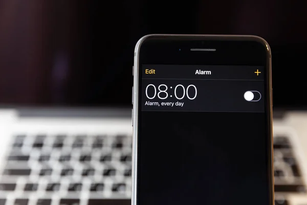 Moskova/Rusya-13 Nisan 2019: siyah iPhone 8 Plus MacBook arka planda. Alarm saati 8 ' de kapalıdır.