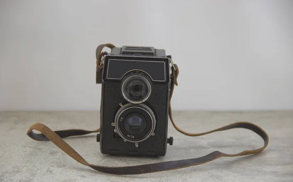 vintage camera with strap on the table