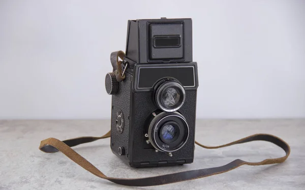 vintage camera with strap on the table