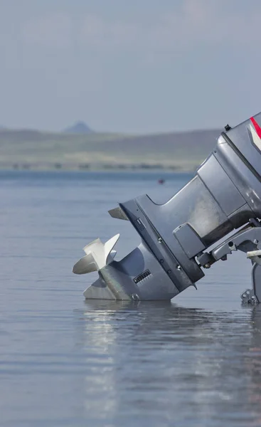 outboard motor lowered into the water