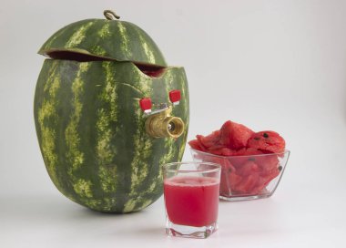 The watermelon c tap to fill the juice on a light background. clipart