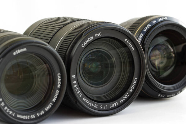 Russia, Krasnoyarsk, July 2019: Set of Canon EF lenses on a white background