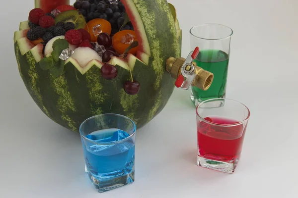 Obstkorb und Saftabfluss. Der Korb besteht aus Wassermelone und ist mit verschiedenen Früchten gefüllt — Stockfoto