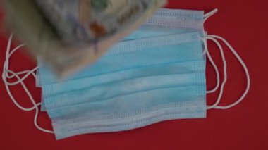 Tıbbi maskeler ve kağıt para faturaları. Tıbbi ürün satın alma kavramı.