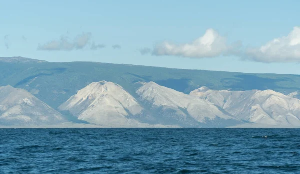 Hill Stone face of Baikal. Guardian of the lake. rock near the shore, view from the water. Beautiful landscape of Siberian Lake. concept of travel. Baikal is the largest freshwater lake in the world.