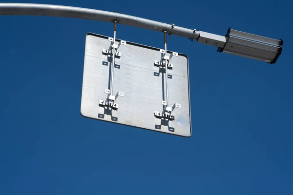 Road sign on the back of the other side. Picture taken against the blue sky. — Stock Photo, Image