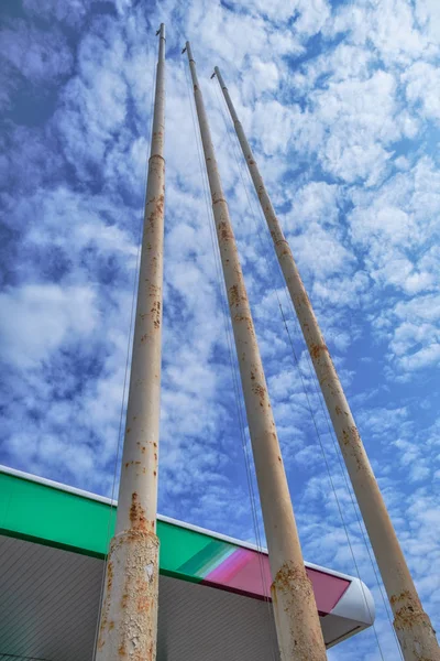 Empty flagpoles on a cloud sky background — Stock Photo, Image