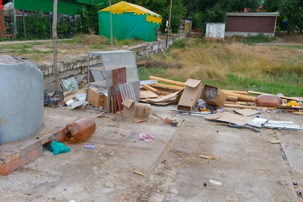 Trash scattered on the street. Parts of packaging and plastic bottles lie on the ground in the city.