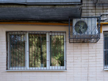 Binanın duvarında büyük bir pencere ve klima var..