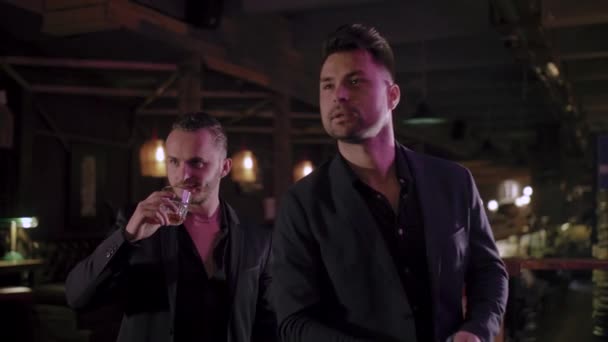 Two men in suits drink whiskey in a bar — Stock Video