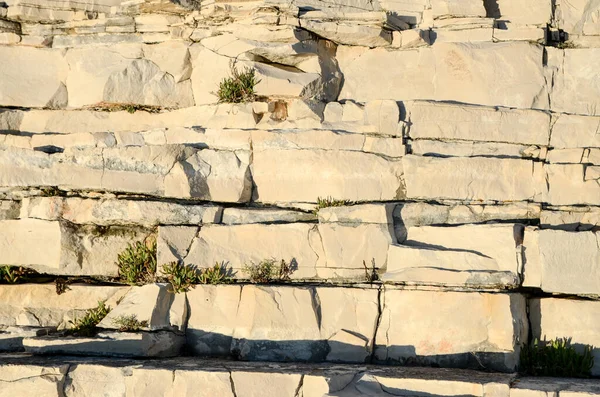 Texture of the rock in nature. Wall of sedimentary rock on coastline. Stone layers of sedimentary rock at sunset. Geological background. Rock pattern near the sea.