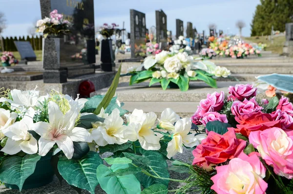 Katolik Mezarlığı 'nda mezar taşları ve çiçekler. Mezarlar ve mezar taşları. Mezarlıktaki siyah mezar taşları. Çiçek süsleme ve mezar. Memorial Center 'daki mermer mezar..