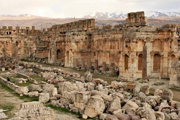 Baalbek - ruins of The Great Court of the ancient Phoenician city with range of mountains at the background