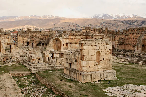 Baalbek - ruins of The Great Court of the ancient Phoenician city with range of mountains at the background