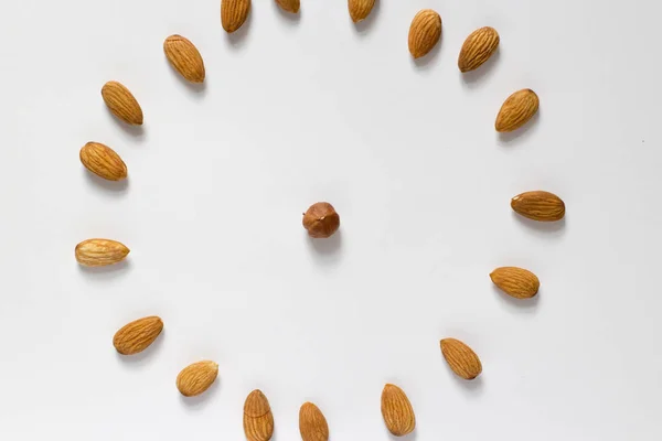 handful of nuts on a white background, almonds and hazelnuts