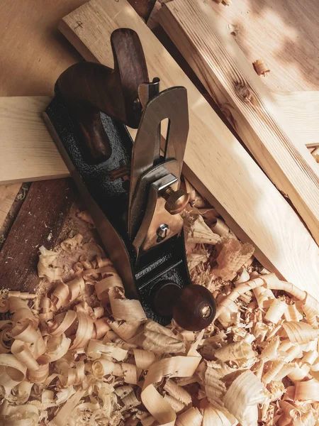 Old manual wood planer hand tool with vintage toned effect.