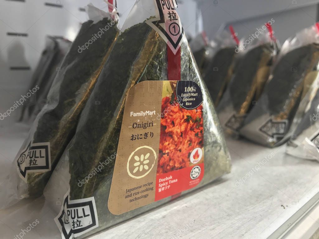 KUALA LUMPUR, MALAYSIA - JULY 9, 2019 : Rows of halal onigiri sold at Family Mart store. Onigiri consists of rice ball in triangular shape, stuffed with various flavors and wrapped in seaweed.