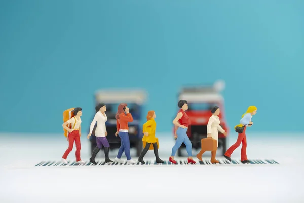 Miniature toys a group of women crossing a road - road safety co — Stock Photo, Image