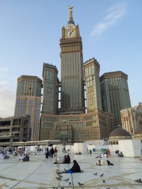Mekke, Suudi Arabistan-31 Temmuz 2019 : Mekke Saat Kulesi (abraj al bait veya Zamzam kulesi) sabah namazından sonra yüksekte dururken, hacı hacılar bir sonraki namaz saatini beklerken rahatlıyorlar..
