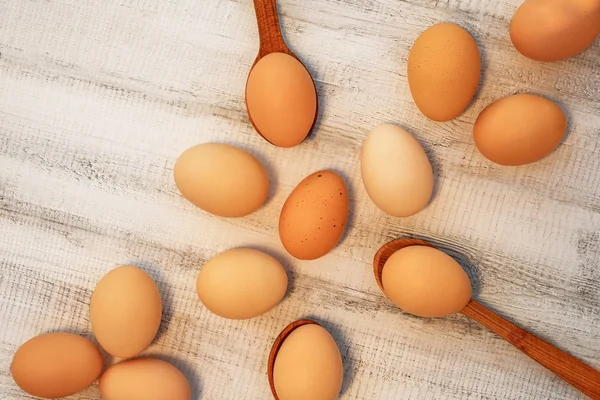 Easter eggs of natural color on a white wooden background. Rutsik style