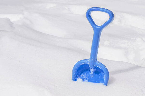 Shovel in snow, ready to removal snow, outdoors