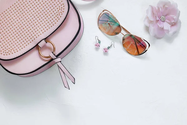Ladies Fashion Accessories. Pink Clutch, sunglasses, earrings Pastel colors Trend
