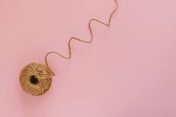 Cuerda de yute cordel sobre un fondo de pastel rosa, arte, minimalista, primer plano, plano laico — Foto de Stock