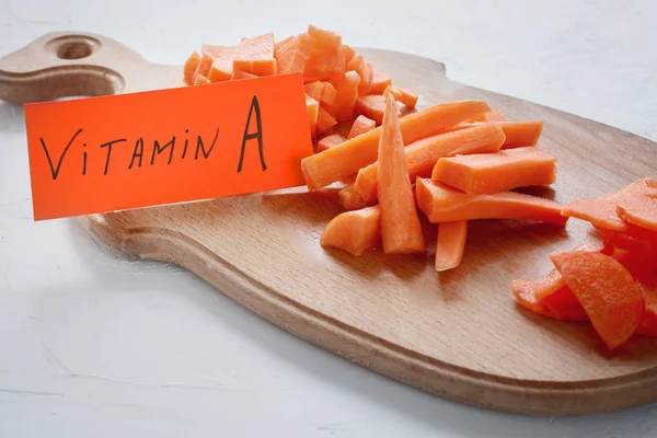 Healthy food - source of vitamin A, variants of slicing carrots on a wooden board
