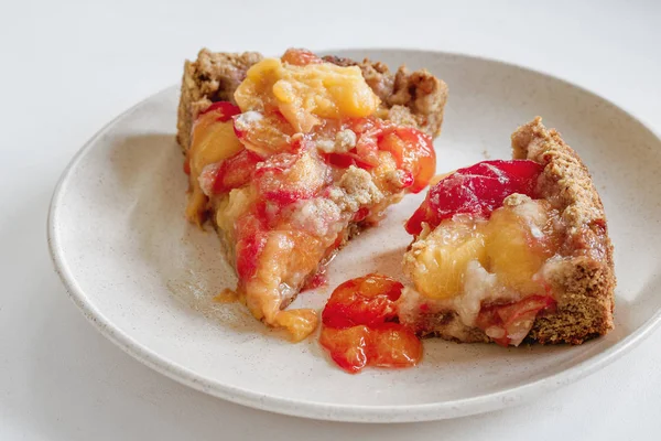 Plum Apricot Pie Home-made close-up on a white background in a cut Stock Image