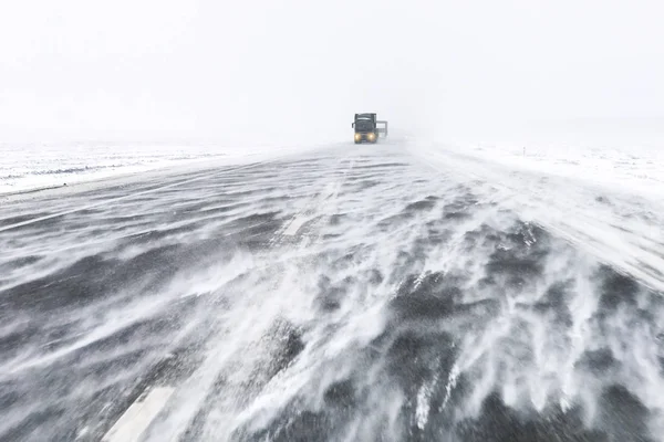 Kar blizzard karayolu trafik. Arabalar karlı asfalt yol üzerinde sürücüler tehlikeli koşullarda kötü görünürlük ve kuvvetli rüzgar ile