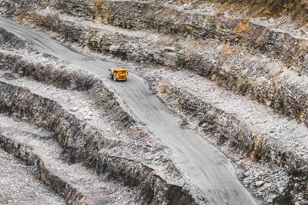 Bir taş ocağı büyük portakal incelemesi kamyonda. Demir cevheri çıkarma. Ağır madencilik ekipmanları. Açık döküm madencilik taş ocağı ironstone manyetit cevheri çıkarılması için yukarıdan görüntüleyin 