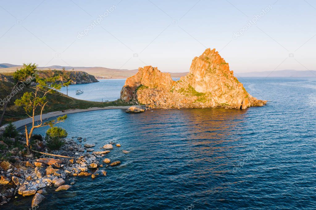 Shamanka Rock at Cape Burhan is natural landmark of Lake Baikal near village of Khuzhir at Olkhon Island, Russia. Nature landscape in tranquil summer morning at sunrise