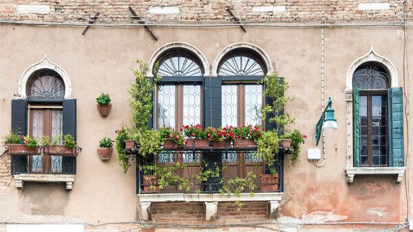 Facade of an old house with a balcony in Venice