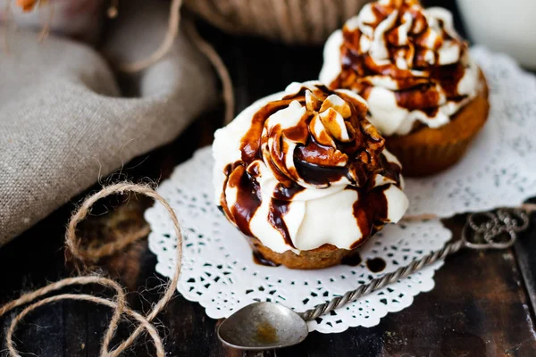 muffins with butter cream and caramel, selective focus