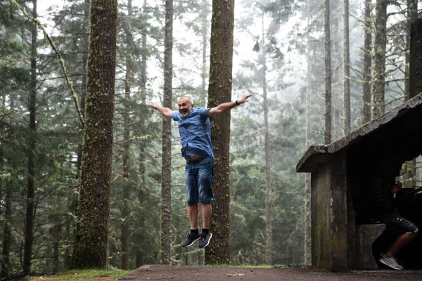 A man jumping in the woods. Blurred motion.Copy   space