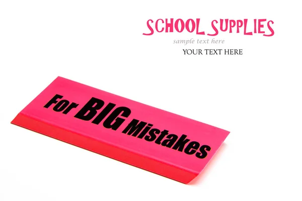 Large red eraser on a white background with message for big mistakes.  Back to school supplies.  Concept erasing big mistakes in life.