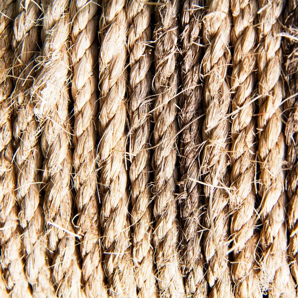Close up of twisted braided hemp rope detail.  Brown thick textured fiber marine rope.