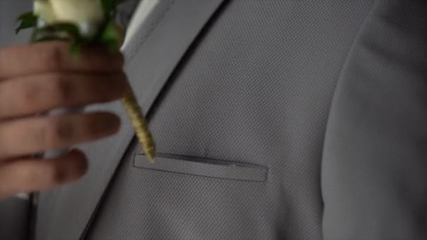 Man Puts Boutonniere White Rose Breast Pocket His Jacket — Stock Video