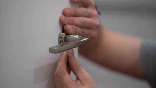 Men Hand Attaches Door Handle Tightens Screw Hexagon Close — Stock Video