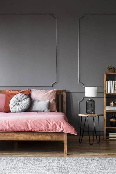 White Lamp Stool Next Wooden Bed Pink Bedsheets Grey Dark — Stock Photo, Image