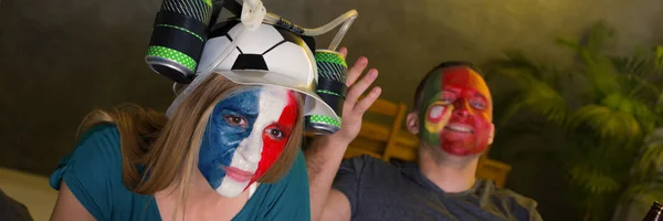 Female French football fan with funny beer hat