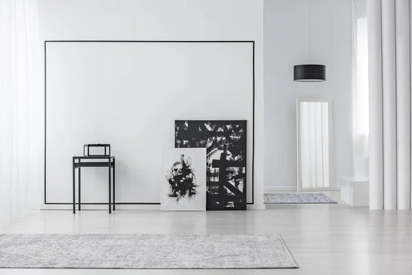 Black and white painting in minimal living room interior with grey carpet and mirror