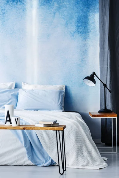 Black Lamp Wooden Table Next White Bed Blue Wall Cozy — Stock Photo, Image