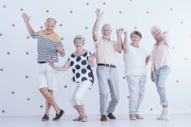 Altın nokta ile beyaz arka plan dans mutlu üst düzey insanlar