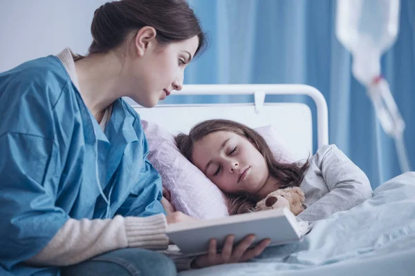 Cuidador Leyendo Libro Una Niña Somnolienta Enferma Clínica — Foto de Stock