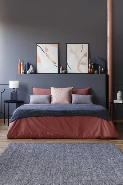담요와 테이블 수채화 포스터와 우아한 어두운 인테리어에 아늑한 침대의 — 스톡 사진