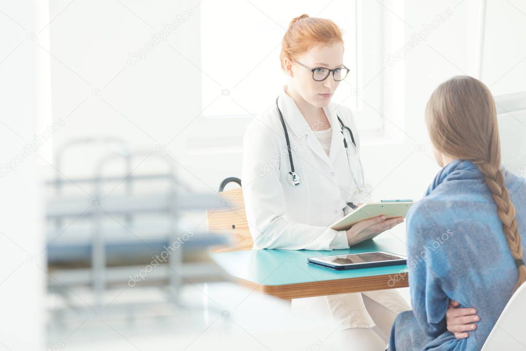 Gynecologist consulting treatment of patient with abdominal pain