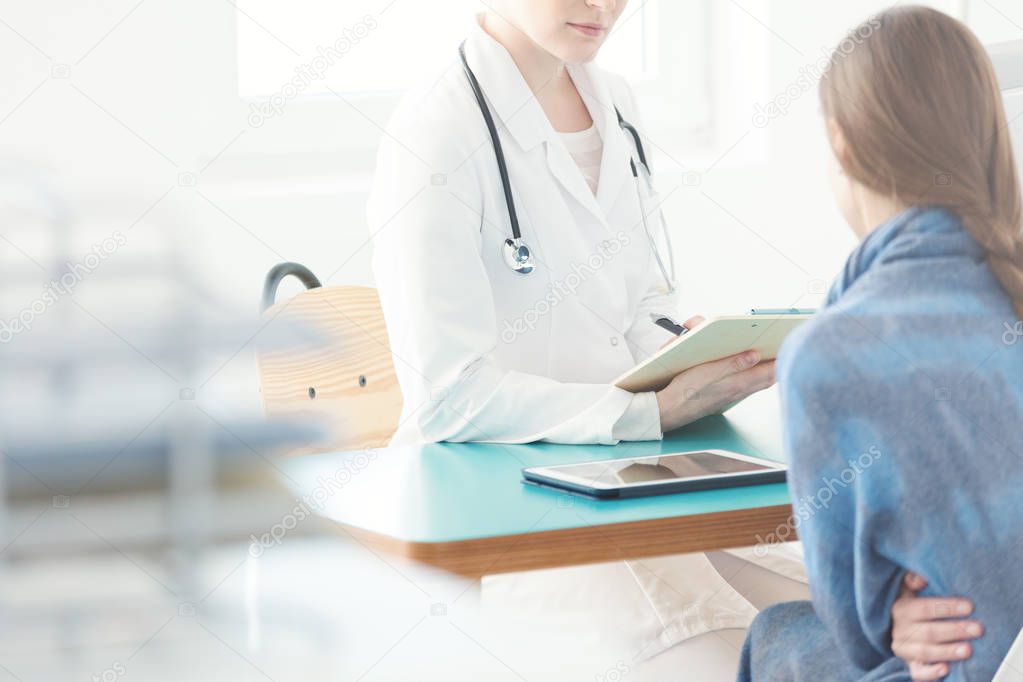 Woman with belly pain during consultation with a gynecologist