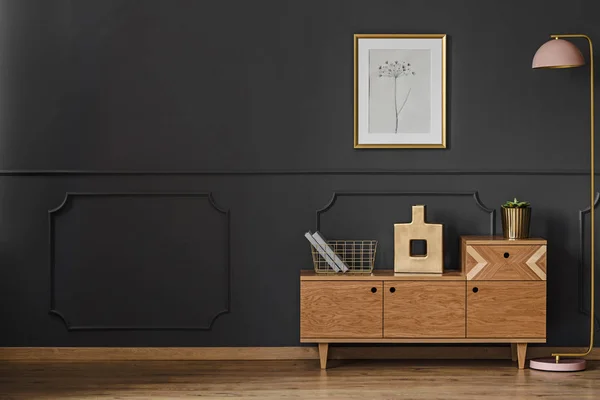 Simple retro living room interior with black walls, wooden floor, cupboard, lamp, ornaments and poster